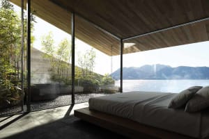 Bright and inviting bedroom with a large bed, natural light, and a view of the outdoors through a large window