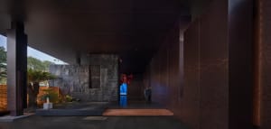 Cozy room with stone walls, a wooden floor, and a stone staircase, lit by dim lighting