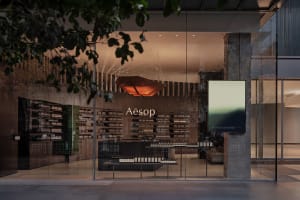 A storefront with a large window display of beauty products and a unique sculpture, creating an inviting and visually appealing atmosphere
