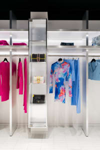 A clothing store with neatly arranged clothes on racks in various styles and colors, creating an inviting atmosphere for customers