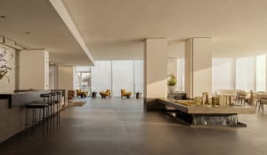 A large, open room with a modern design, natural light, and white finishes, featuring a couch, chairs, and a dining table