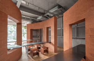 A warm and inviting restaurant dining area with a brick wall, wooden chairs, and a dining table, set in a soft and diffused lighting environment