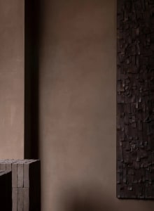 Cozy living space with a brick wall and wooden floor, dimly lit