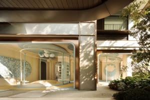 A bright and inviting office space with a large glass window, surrounded by modern architecture and natural light