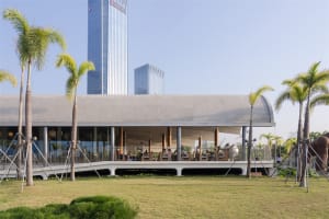 A spacious modern dining area with a large table and chairs, surrounded by a sleek and functional building with natural light pouring in