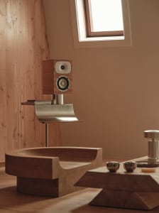 Bathroom with a wooden bench, sink, and window, featuring natural light and a warm atmosphere