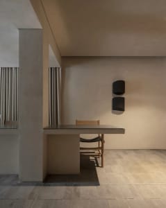 Cozy modern kitchen with a wooden dining table, brown chairs, and dim lighting