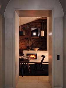 Cozy modern living space with a wooden floor, a fireplace, and dim lighting