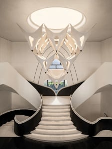 A modern staircase with a white railing and white stone wall, bathed in natural sunlight