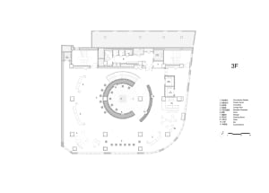 2D top-down floor plan of a modern building with a circular center, surrounded by other rooms, featuring concrete and glass materials, with natural lighting and an open and spacious atmosphere