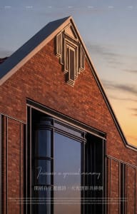 A traditional church with a brick exterior and a glass window, set against a warm sunset background