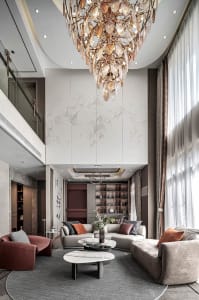 Cozy modern living space with a chandelier, vases, plants, and comfortable furniture