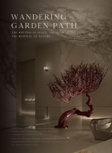 A modern room with a pink tree-like sculpture, white walls, and decorative elements, conveying a calm and serene atmosphere