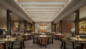 A modern restaurant with a large dining area featuring wooden tables, metal accents, and dim lighting, creating a cozy and intimate atmosphere