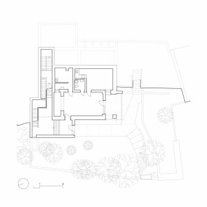 Black and white architectural floor plan of a modern two-story residential house featuring multiple bedrooms, living areas, kitchen, bathrooms, staircases, and a landscaped garden with trees.