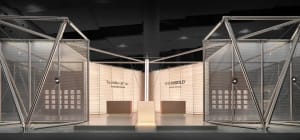 Modern exhibition booth featuring large triangular stainless steel frames, sheer mesh screens, and illuminated central display platforms with brand signage for Higold and Tourbillon.