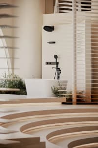Modern minimalist bathroom with white freestanding bathtub, black matte fixtures, curved concrete steps, and horizontal wooden blinds allowing soft natural light.