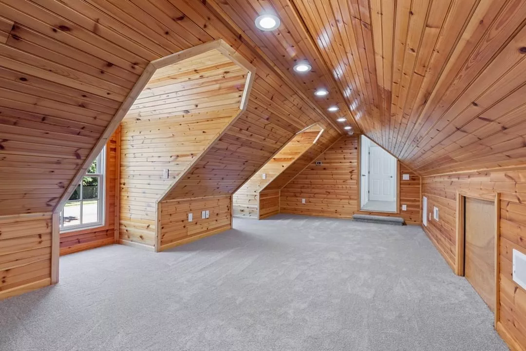 Attic finish with lighting and organized storage zones.