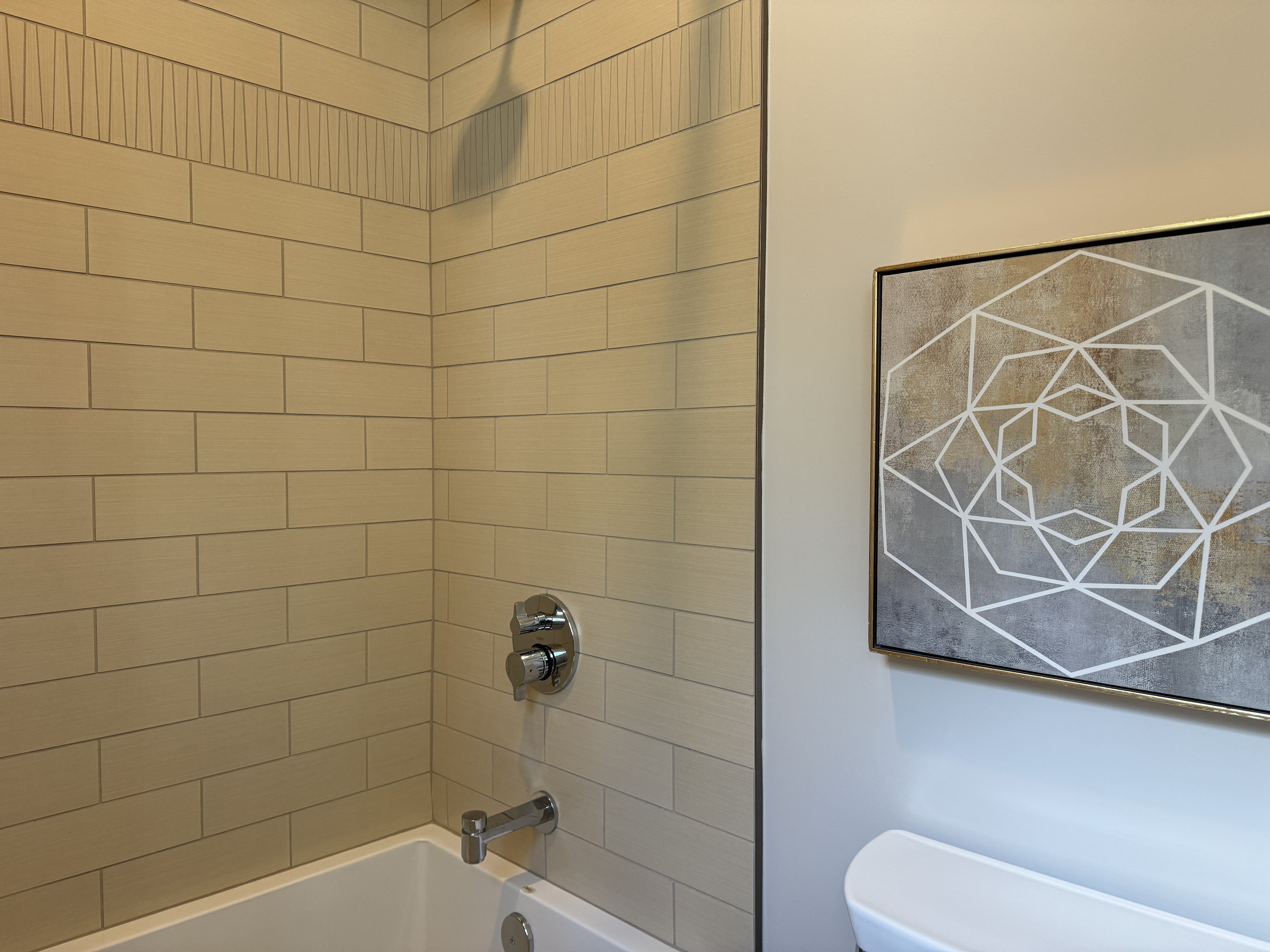 Seattle bathroom remodel with new tile and fixtures, showing a fresh modern look in a compact space.