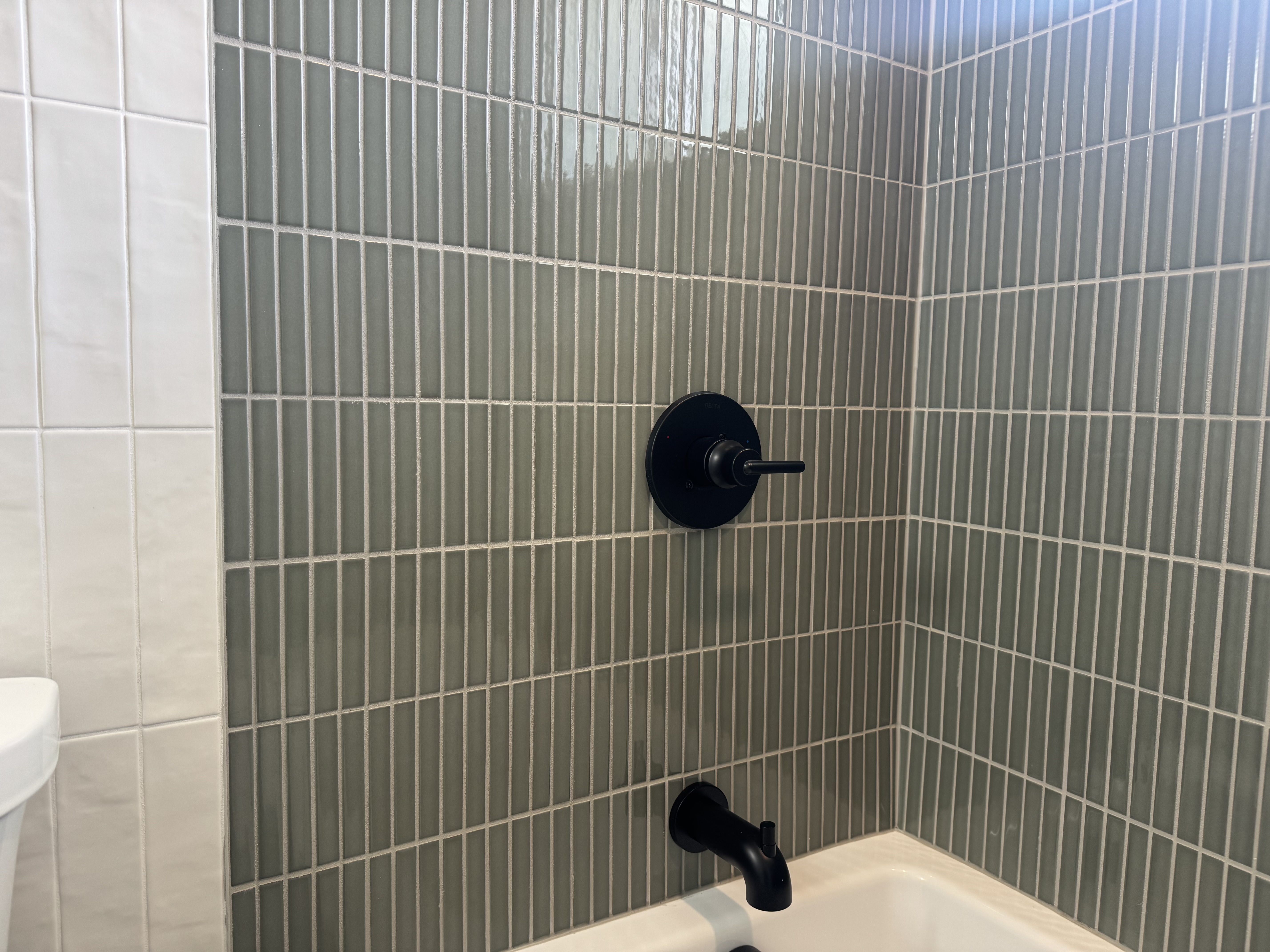 A small Seattle bathroom with old tiles and fixtures in need of remodeling.