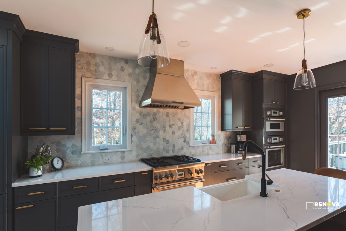 Bellevue kitchen renovation with dark cabinets, white marble counters, stainless appliances, custom range hood, pendant lights, and center island - complete kitchen remodeling.