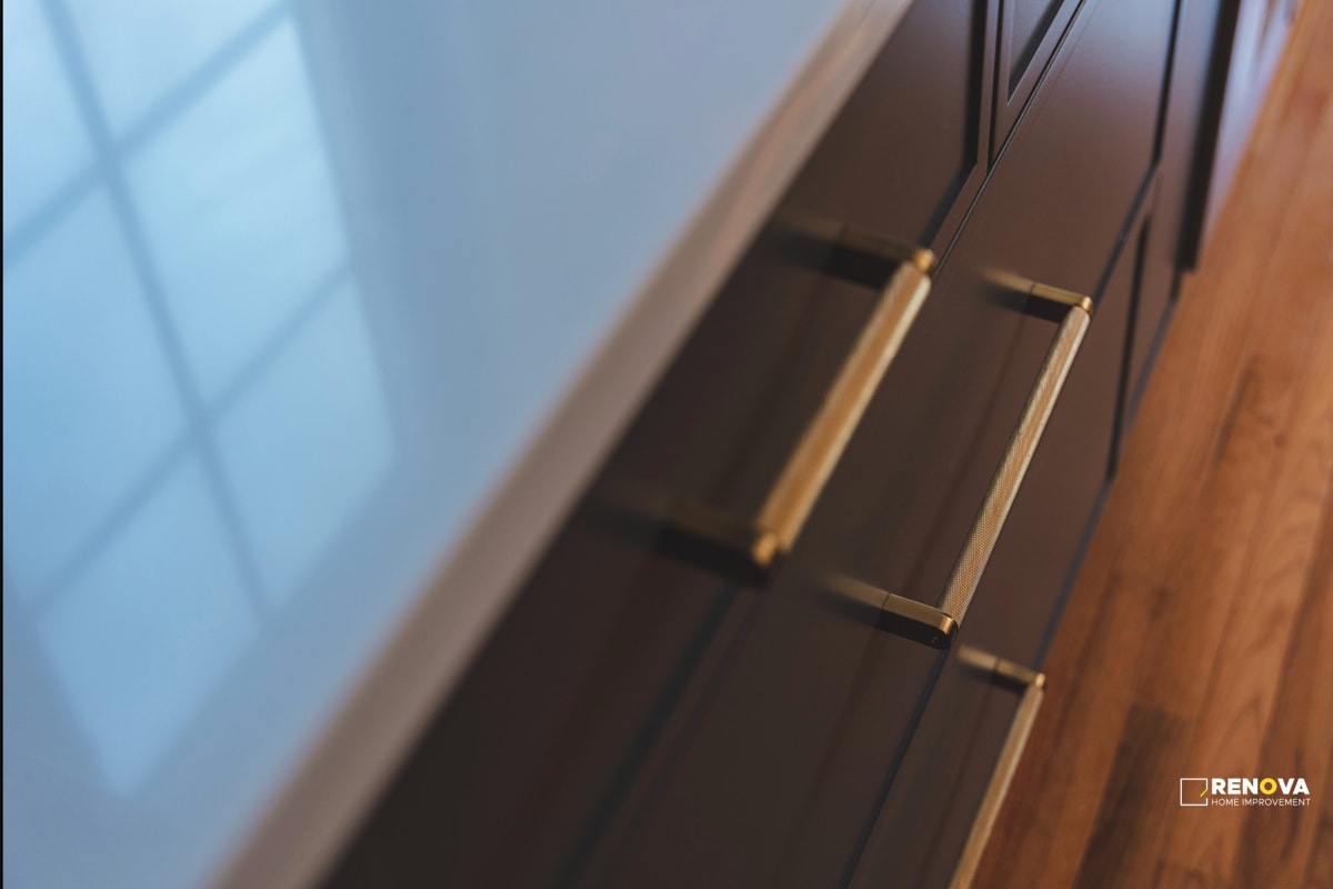 Kitchen remodel Bellevue detail showing custom dark cabinetry with gold hardware and quality countertops - professional kitchen renovation by Renova contractors.