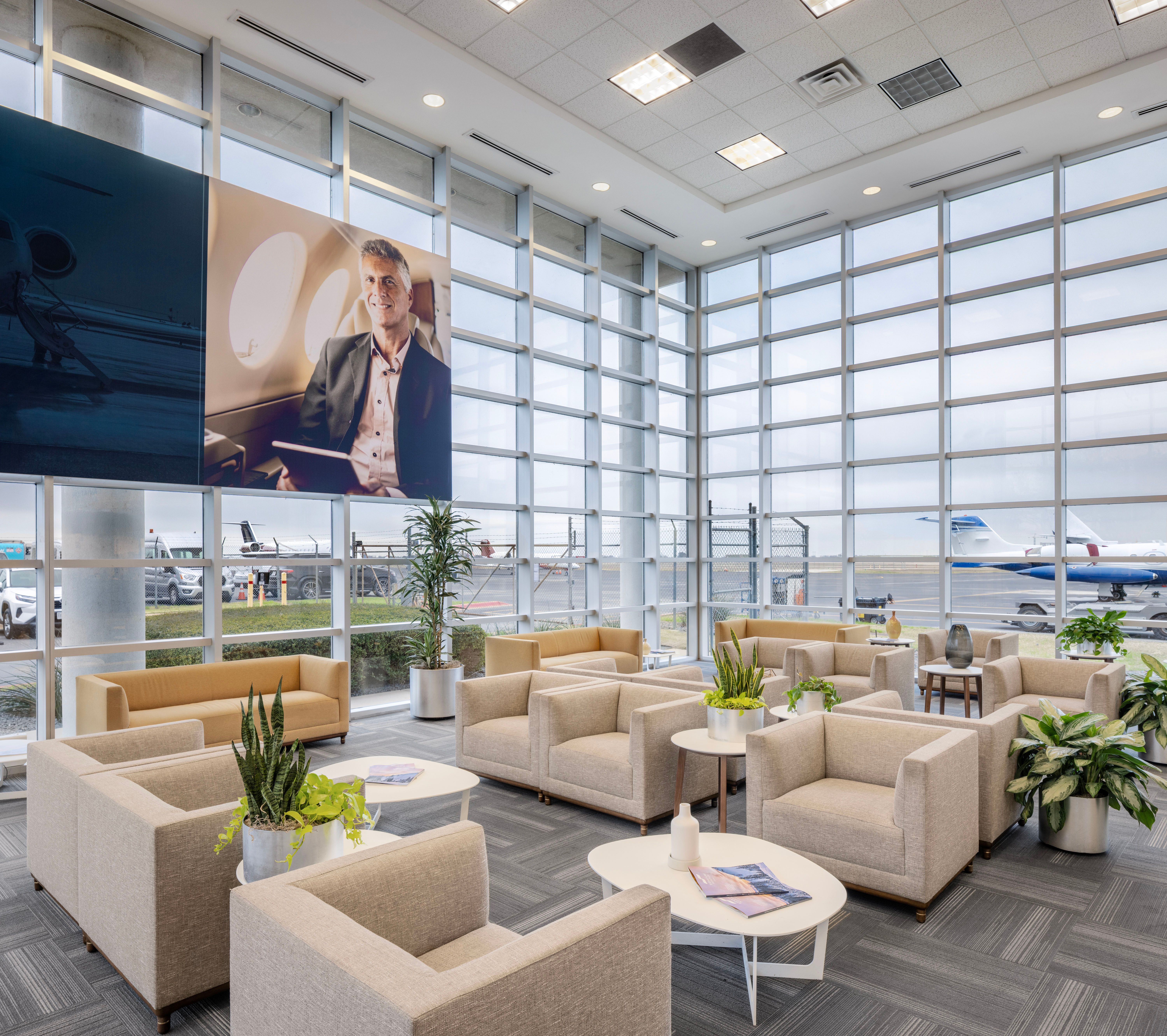 Passenger lounge inside Signature Aviation AUS featuring seating, natural light, and views of the airfield for business aviation travelers visiting Austin during Formula 1 race week.