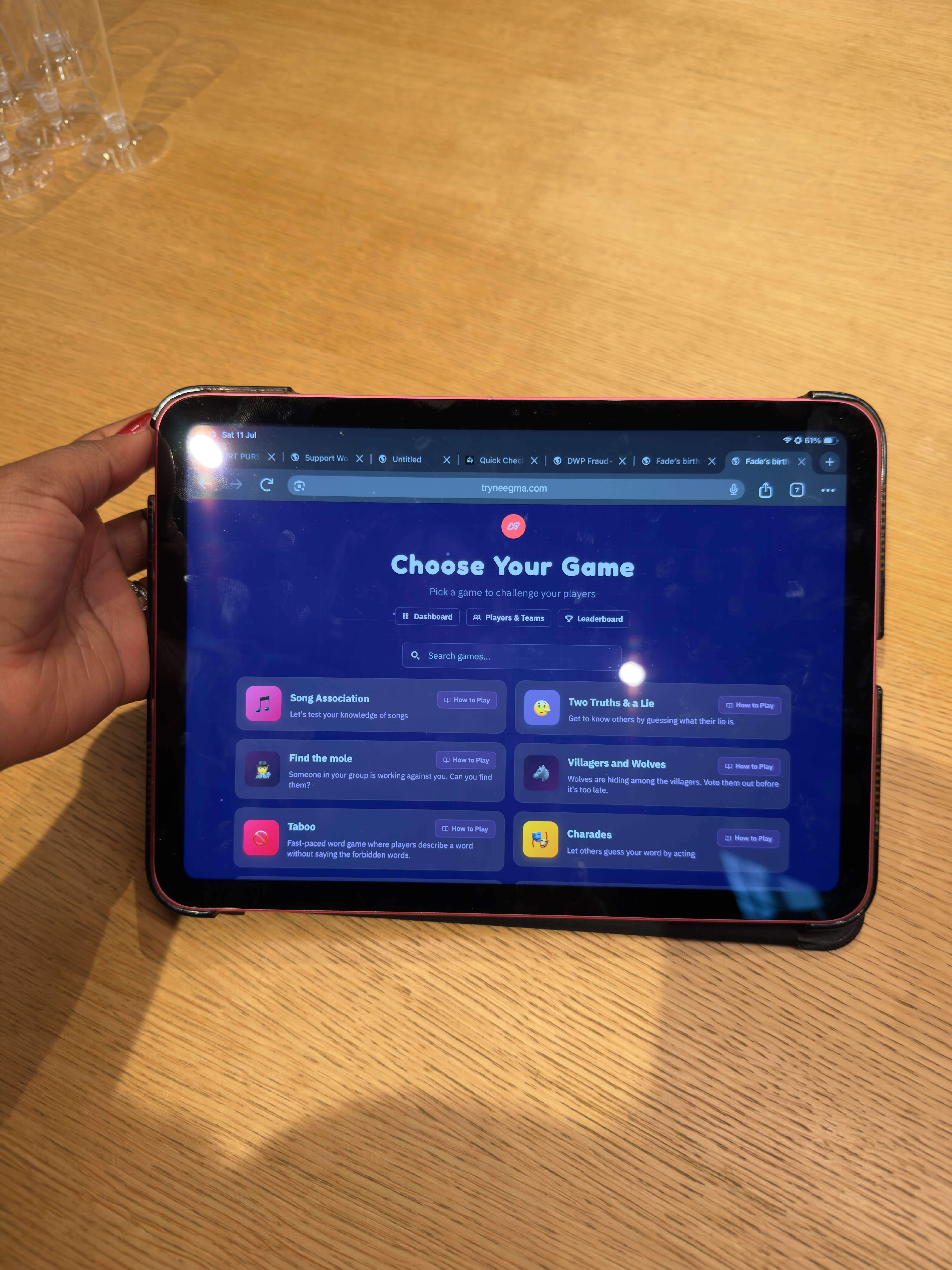 Guests choosing the next game on a tablet at an intimate birthday party
