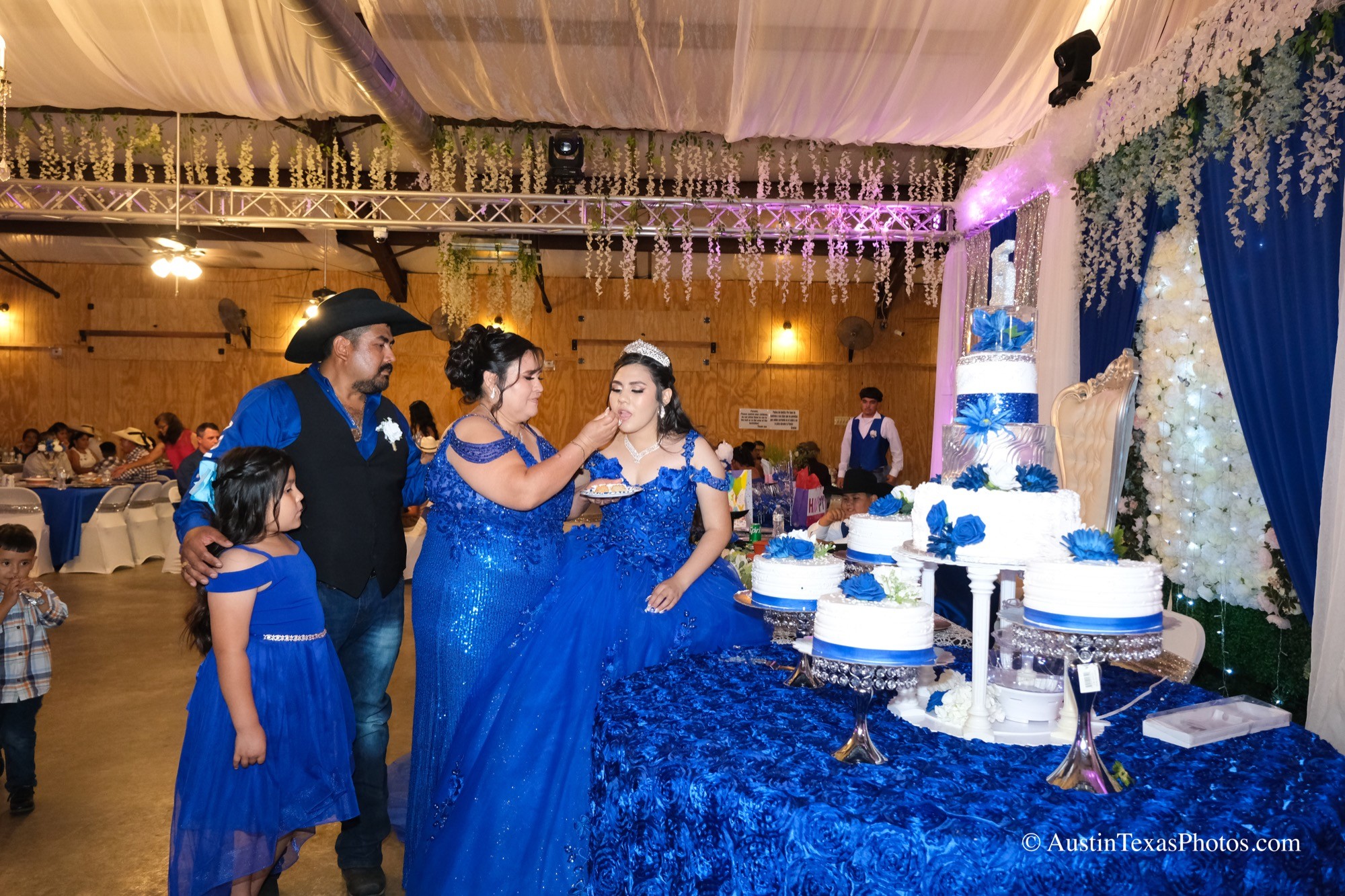 Mother giving her daughter a bite of cake after the cake cutting