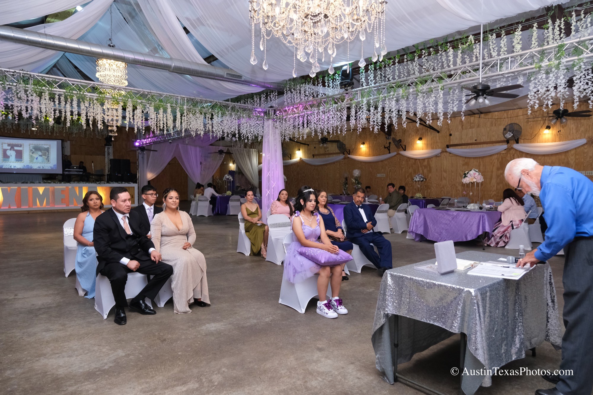Quinceañera receiving a blessing inside the event center