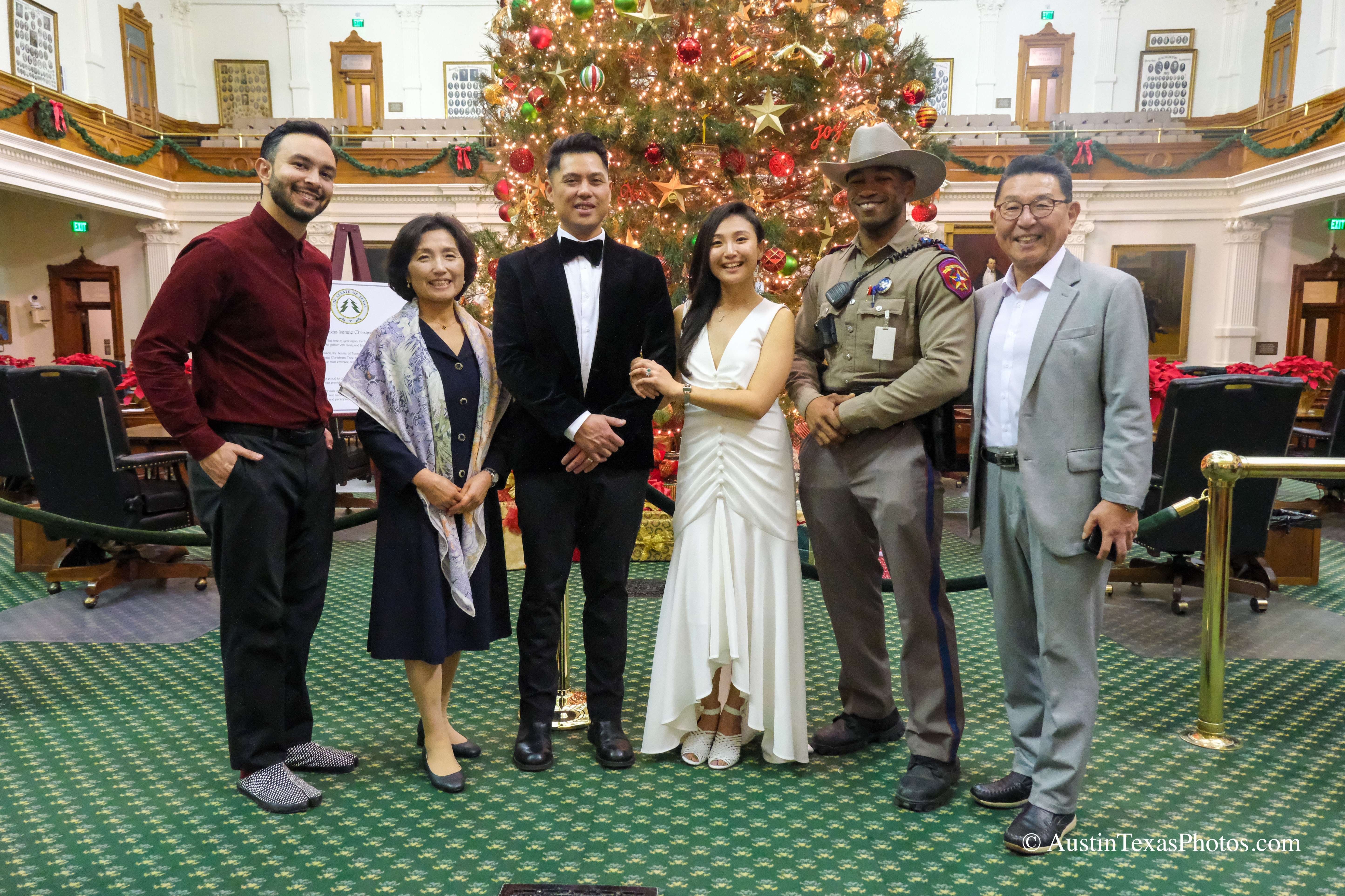Wedding party group portrait with Christmas tree inside the Texas State Capitol, Austin, Texas