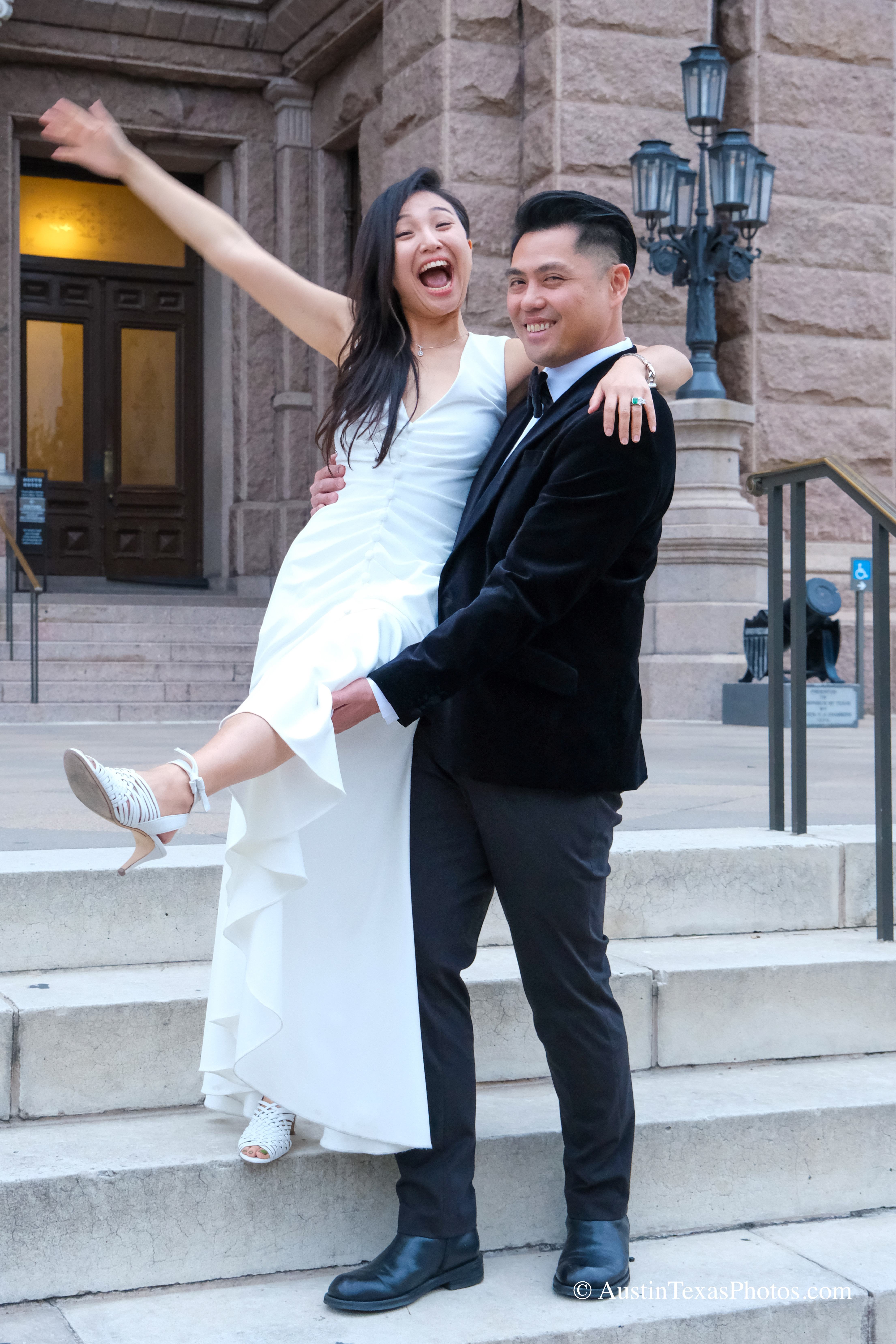 Groom lifting bride on the Texas State Capitol stairs, Austin, Texas