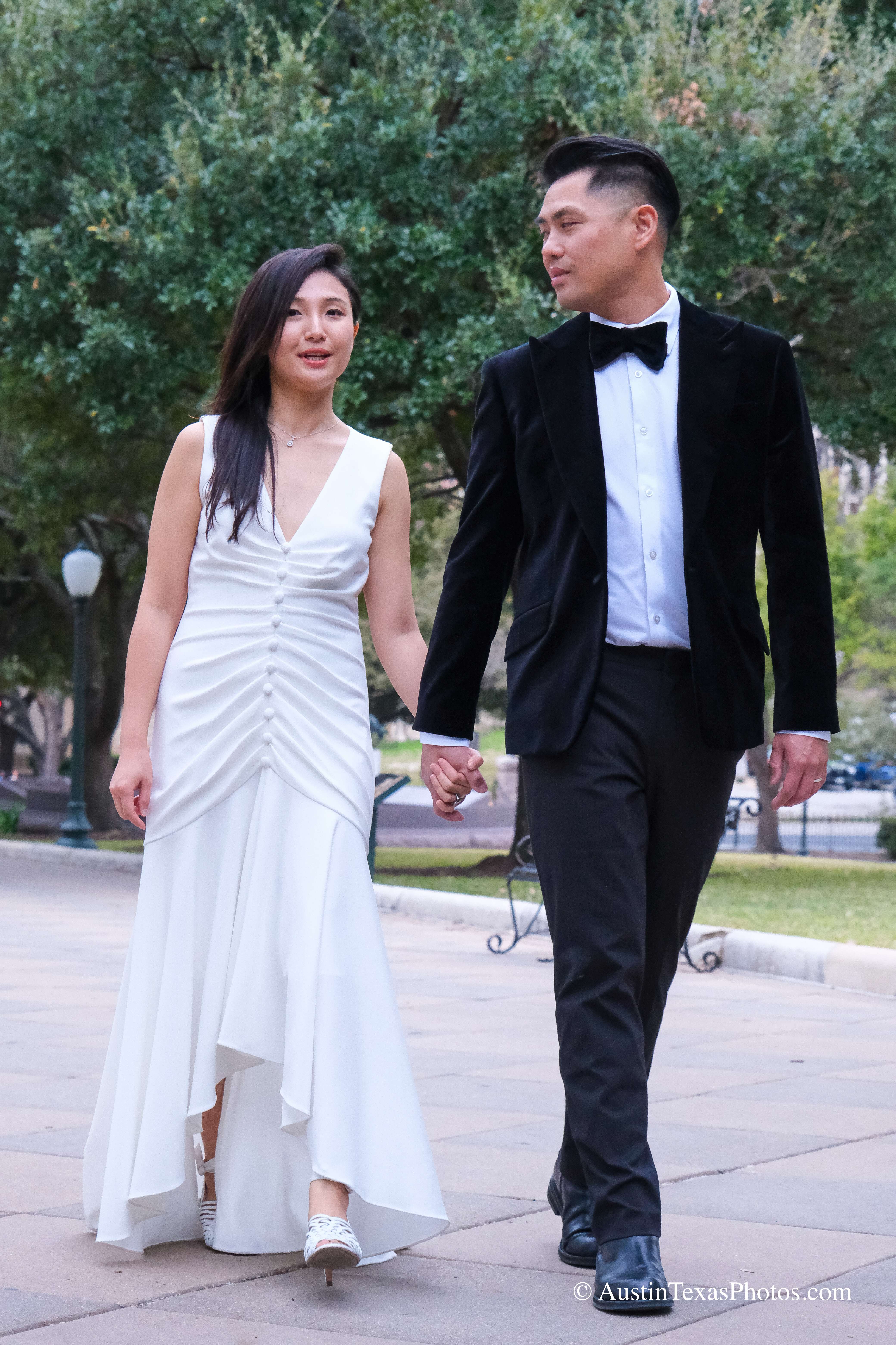 Bride and groom walking together on the Texas State Capitol grounds, Austin, Texas