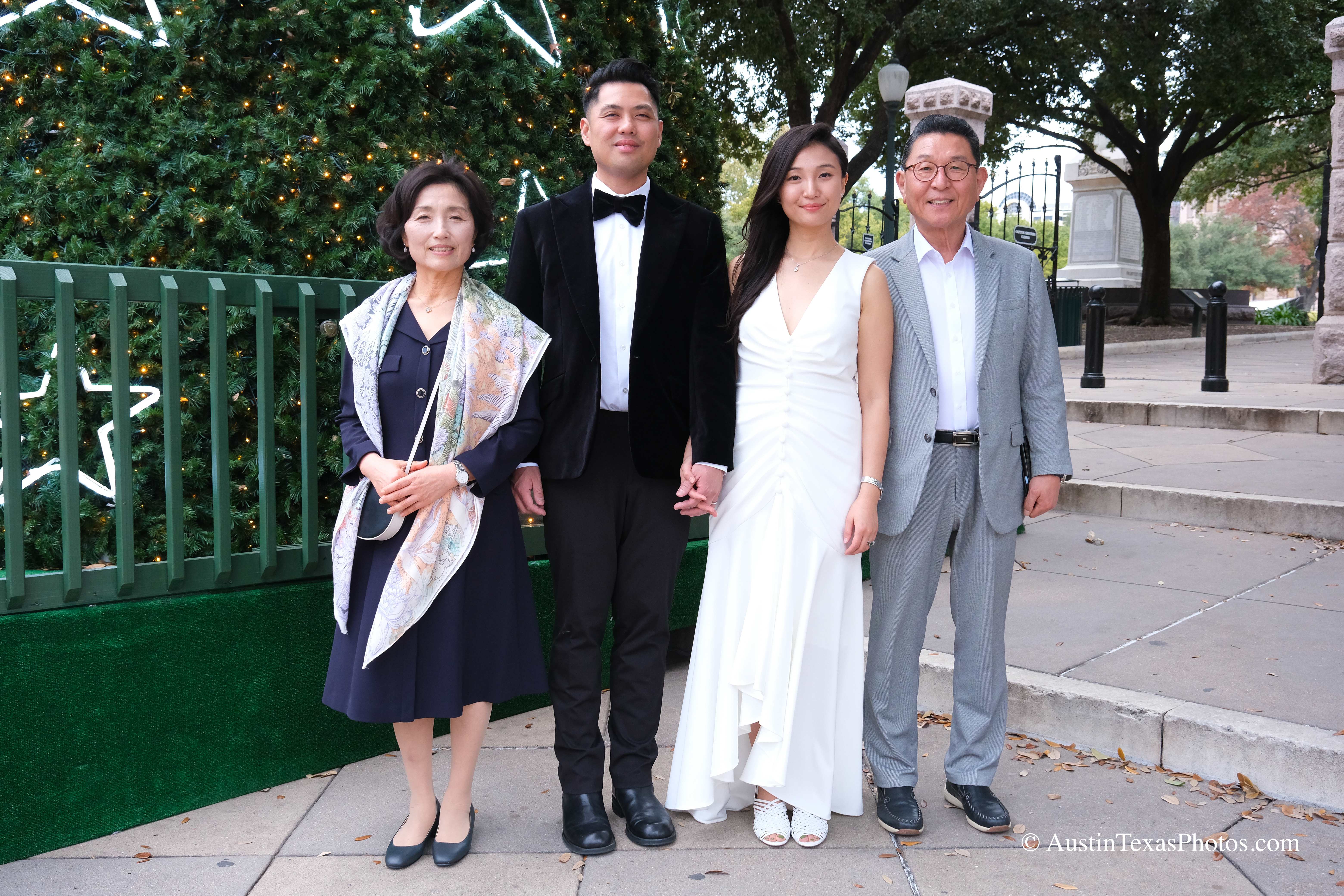 Bride and groom with parents outside the downtown Austin courthouse
