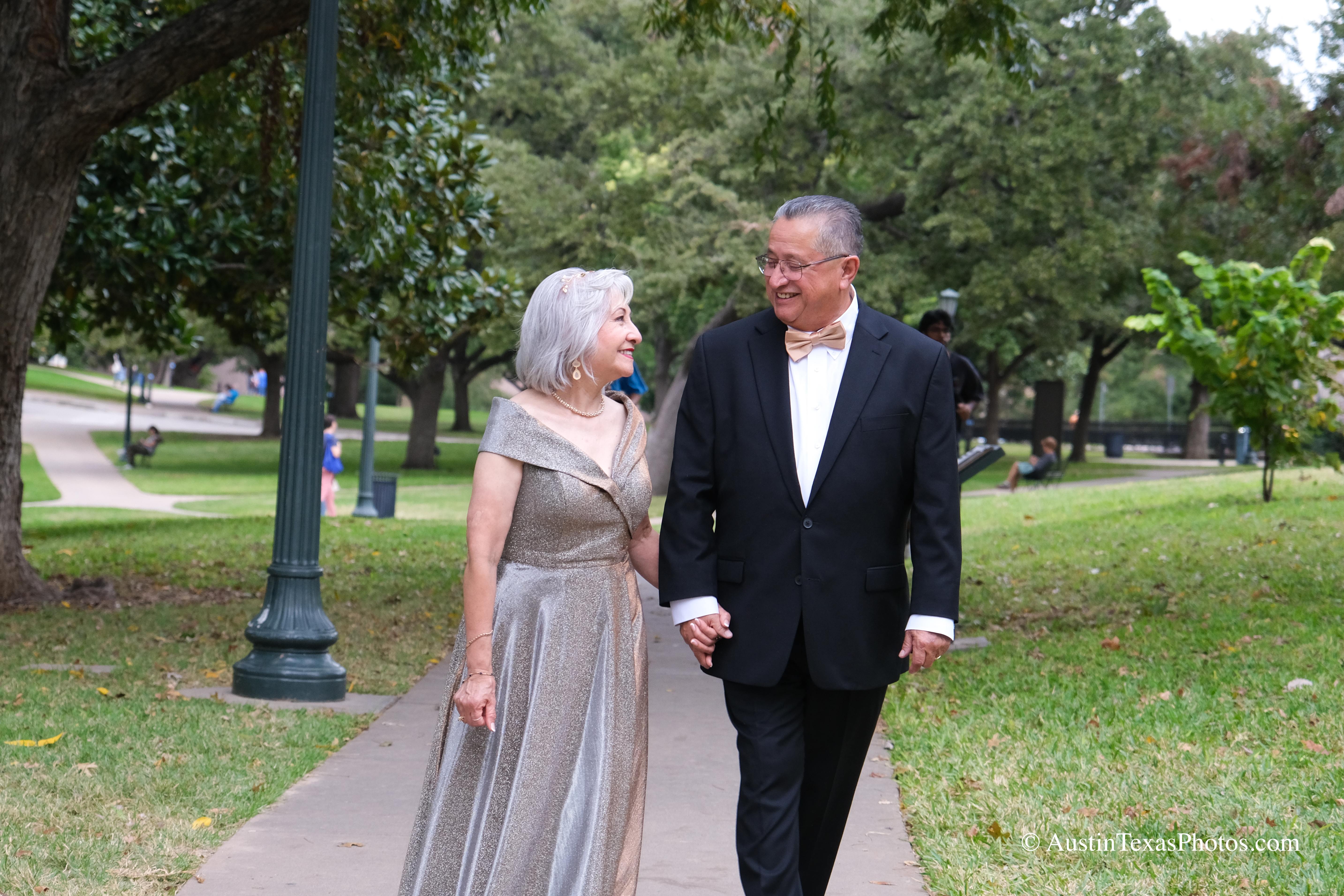 Bride and groom walking together at the Texas State Capitol, groom gazing at bride, Austin, Texas