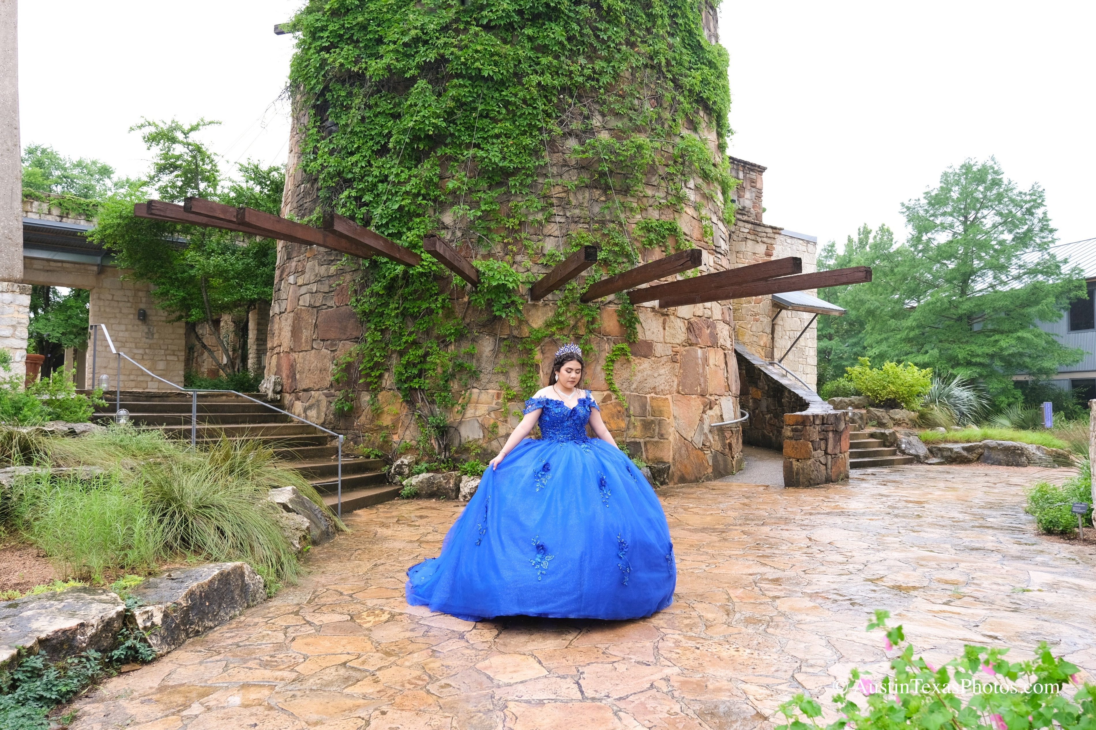 Quinceañera in royal blue gown at the stone tower courtyard, Lady Bird Johnson Wildflower Center, Austin
