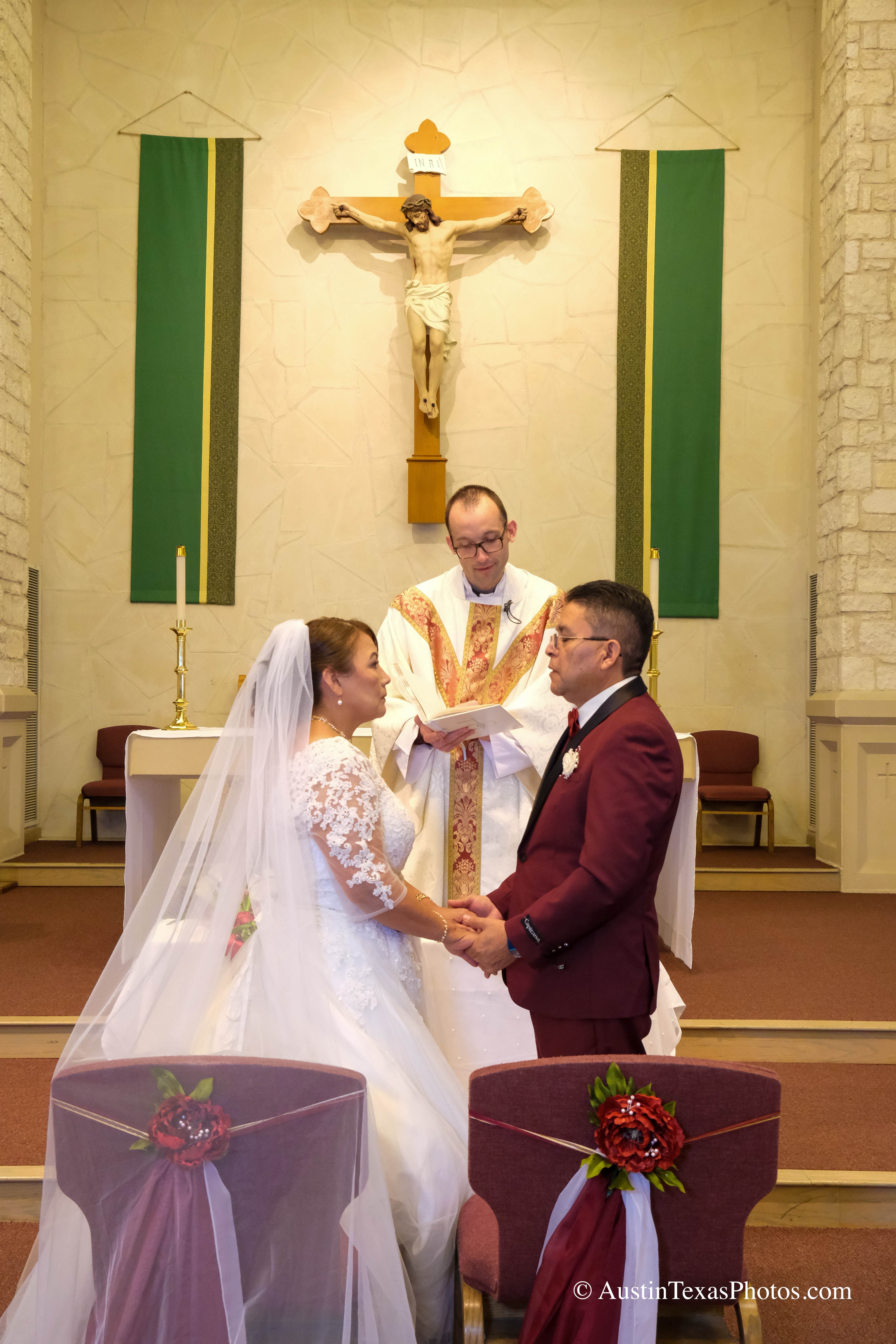 Bride and groom about to kiss at the altar during wedding ceremony