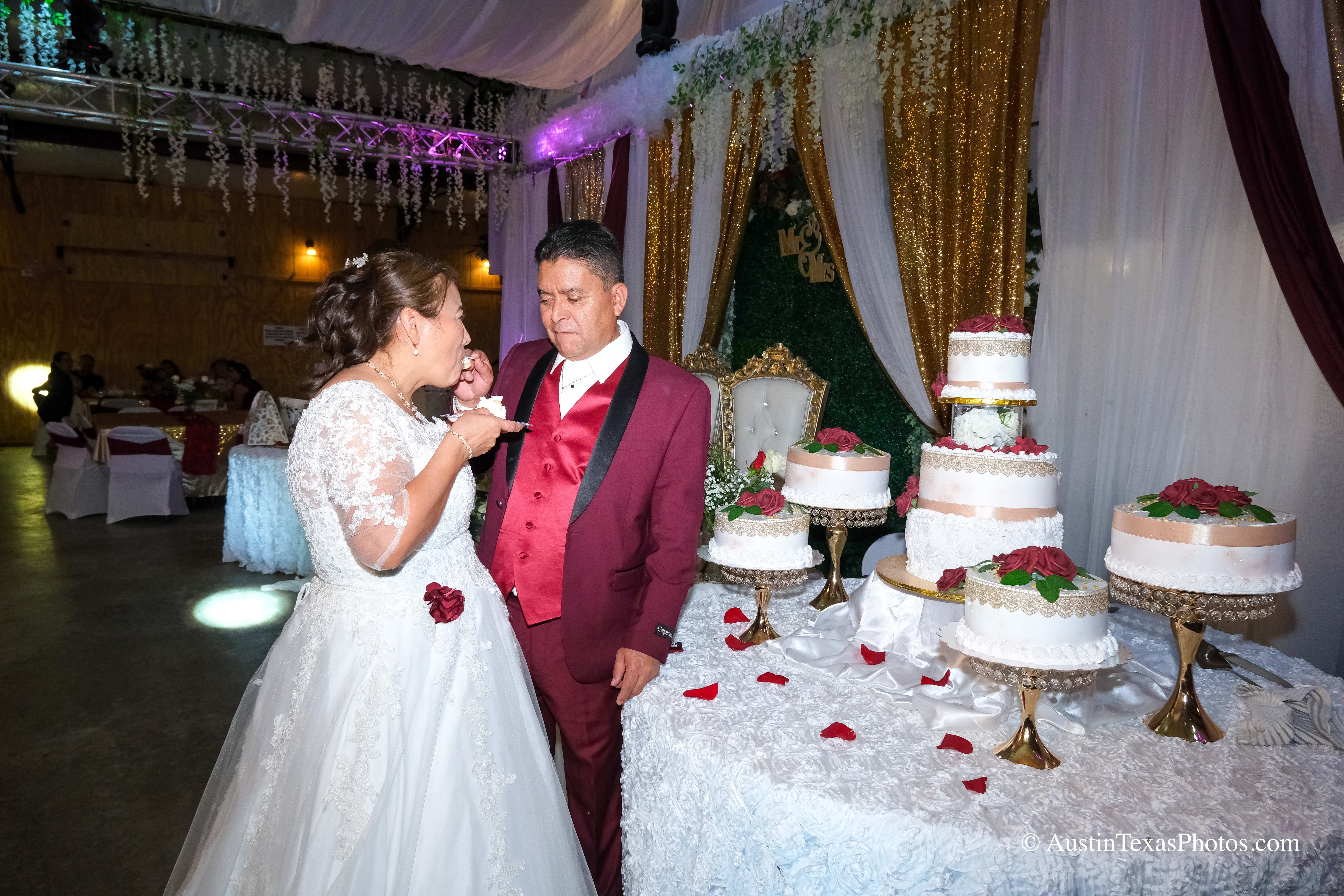 Bride and groom cutting wedding cake at reception