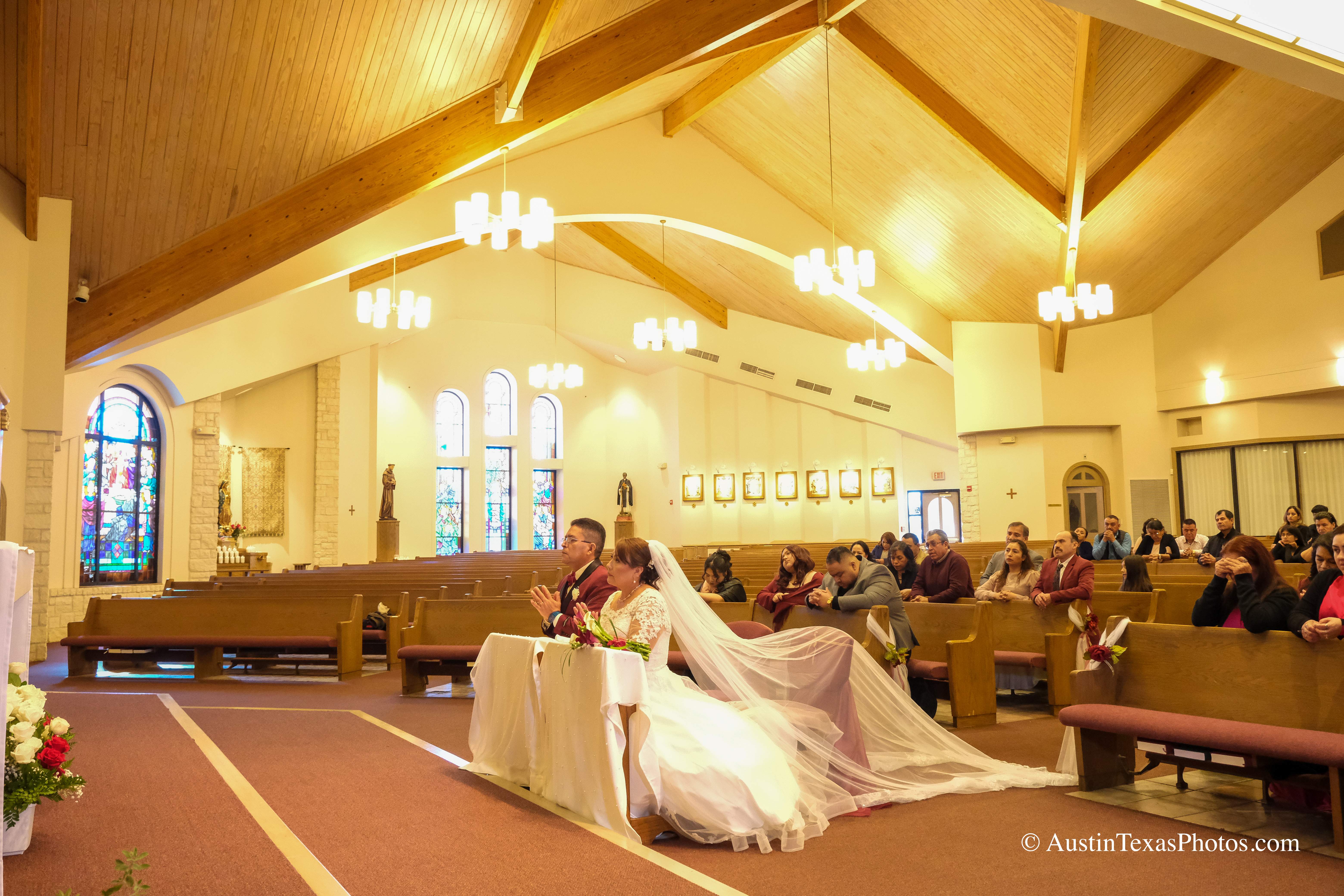 Wide view inside Santa Cruz Catholic Church during wedding mass in Buda, Texas