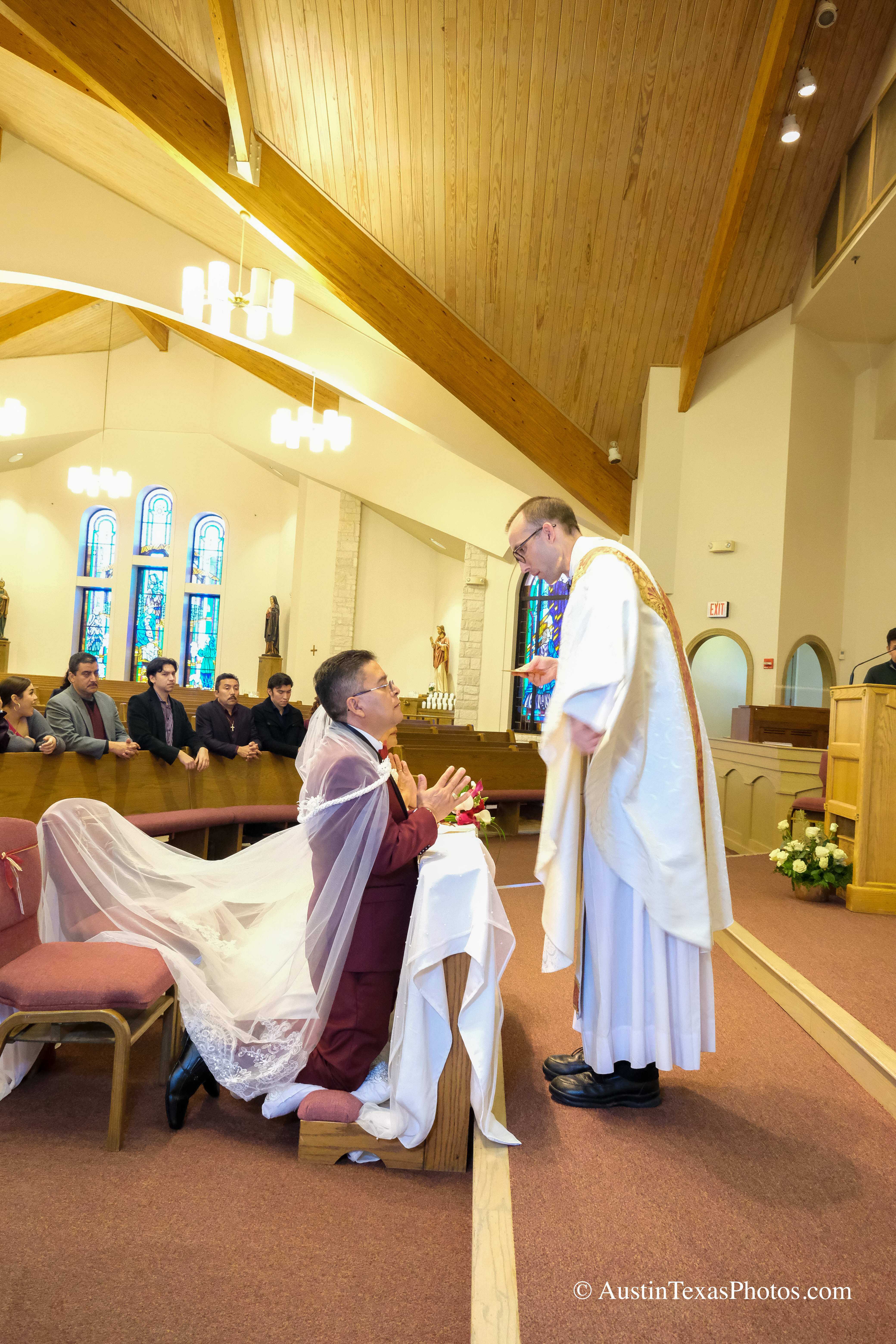 Bride and groom receiving Eucharist during wedding mass at Santa Cruz Catholic Church