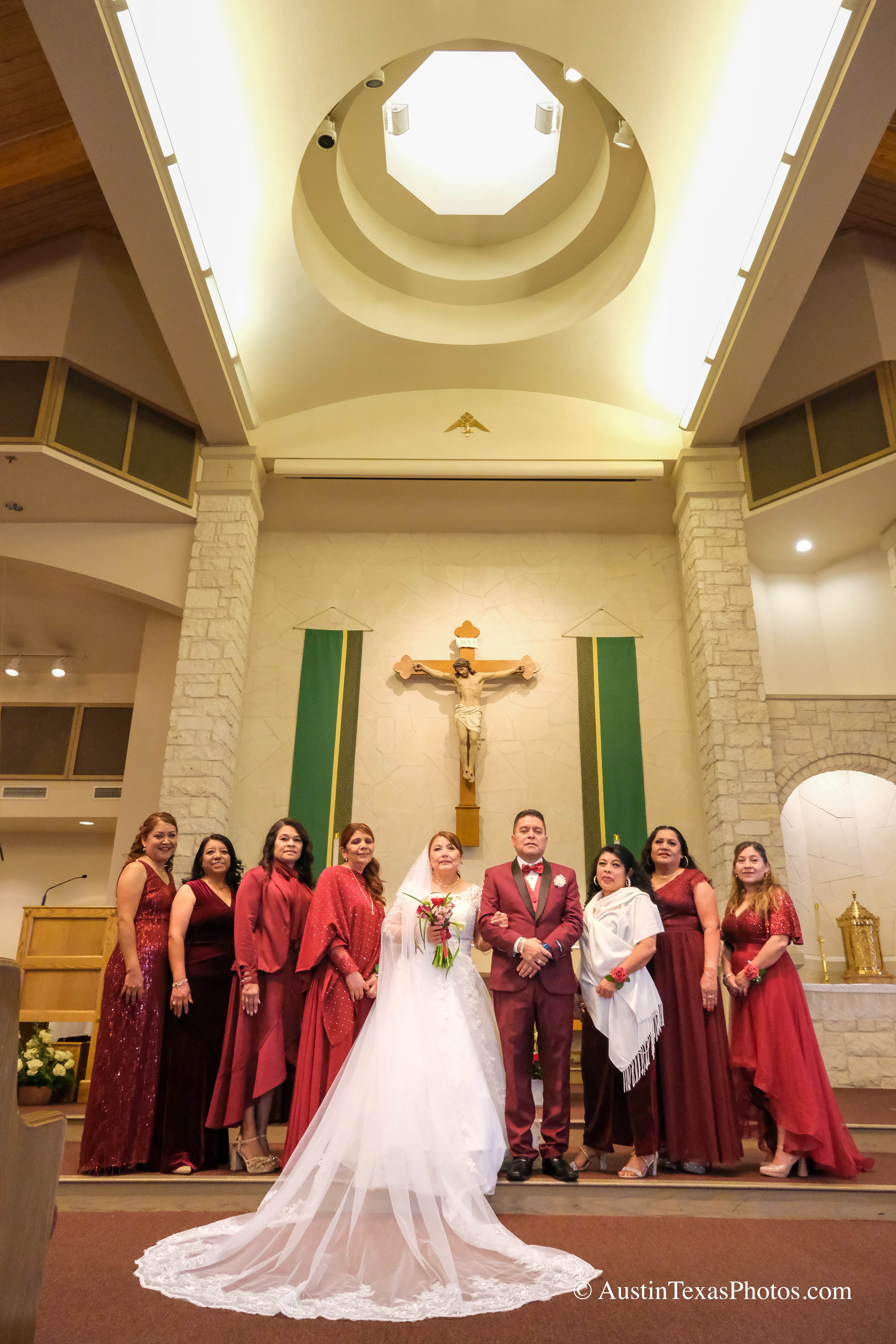 Extended wedding family portrait at the altar with bride and groom