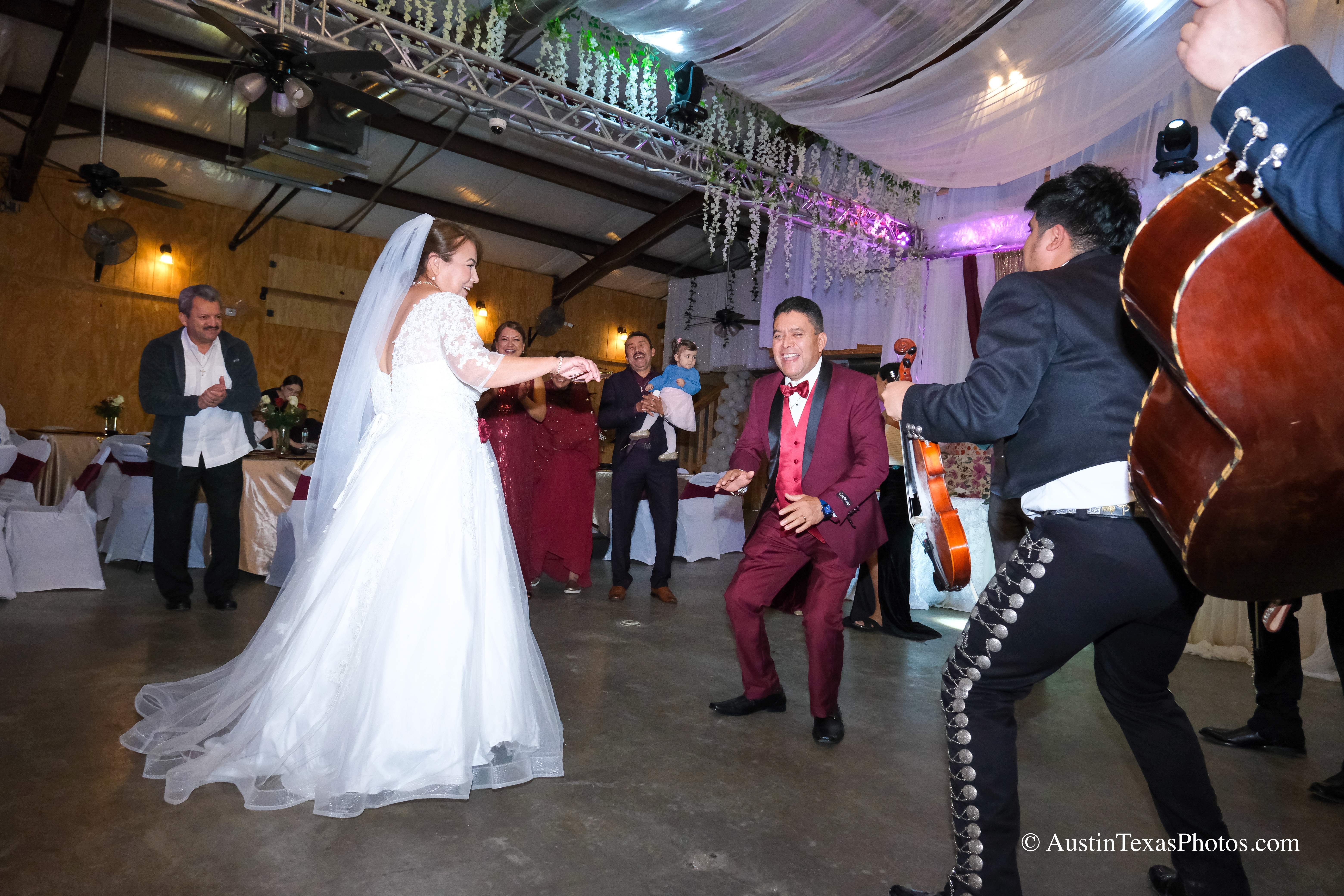 Bride and groom dancing with mariachi band at wedding reception