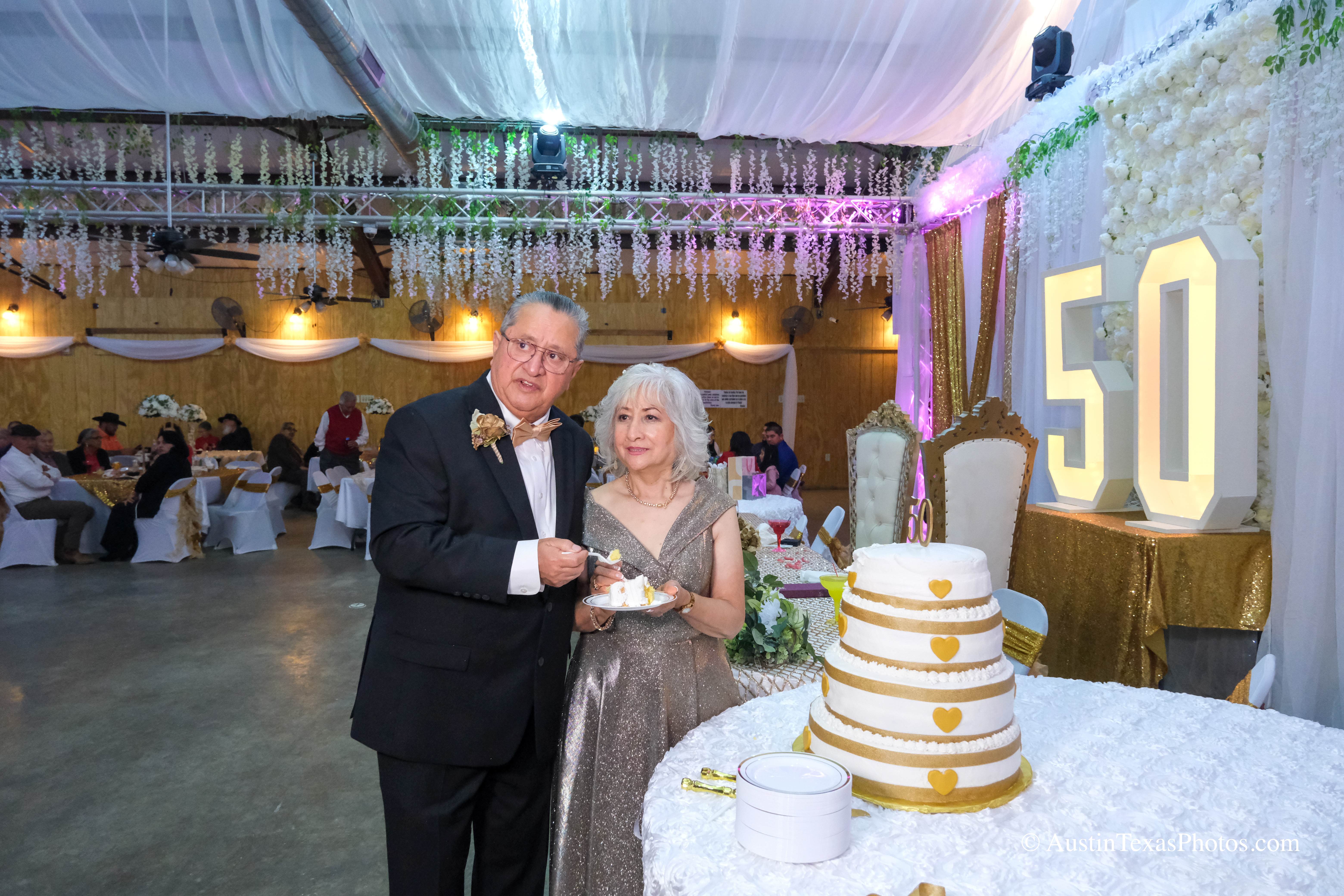 Bride and groom feeding each other wedding cake at reception