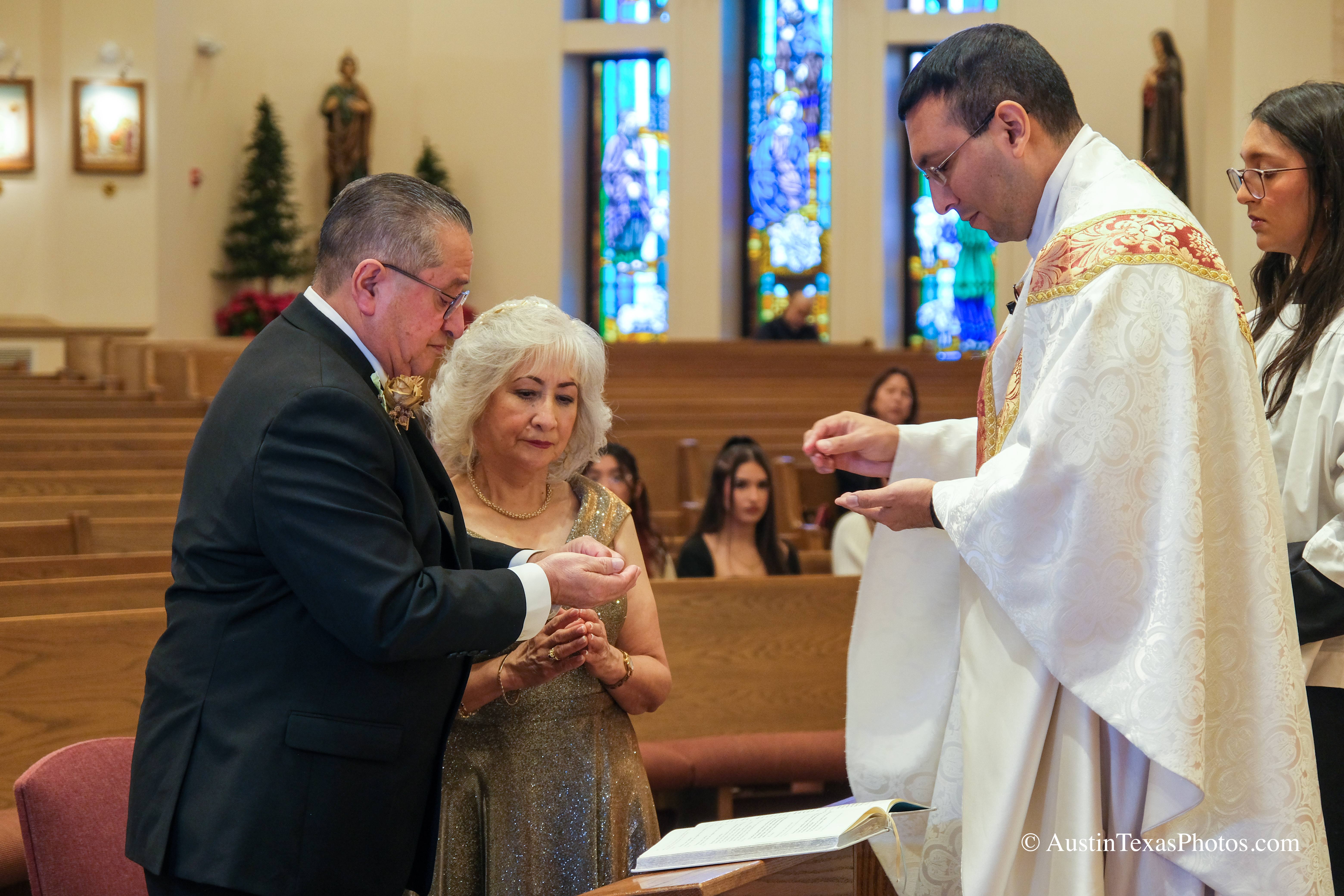 Close-up of bride and groom wedding rings during Catholic wedding ceremony