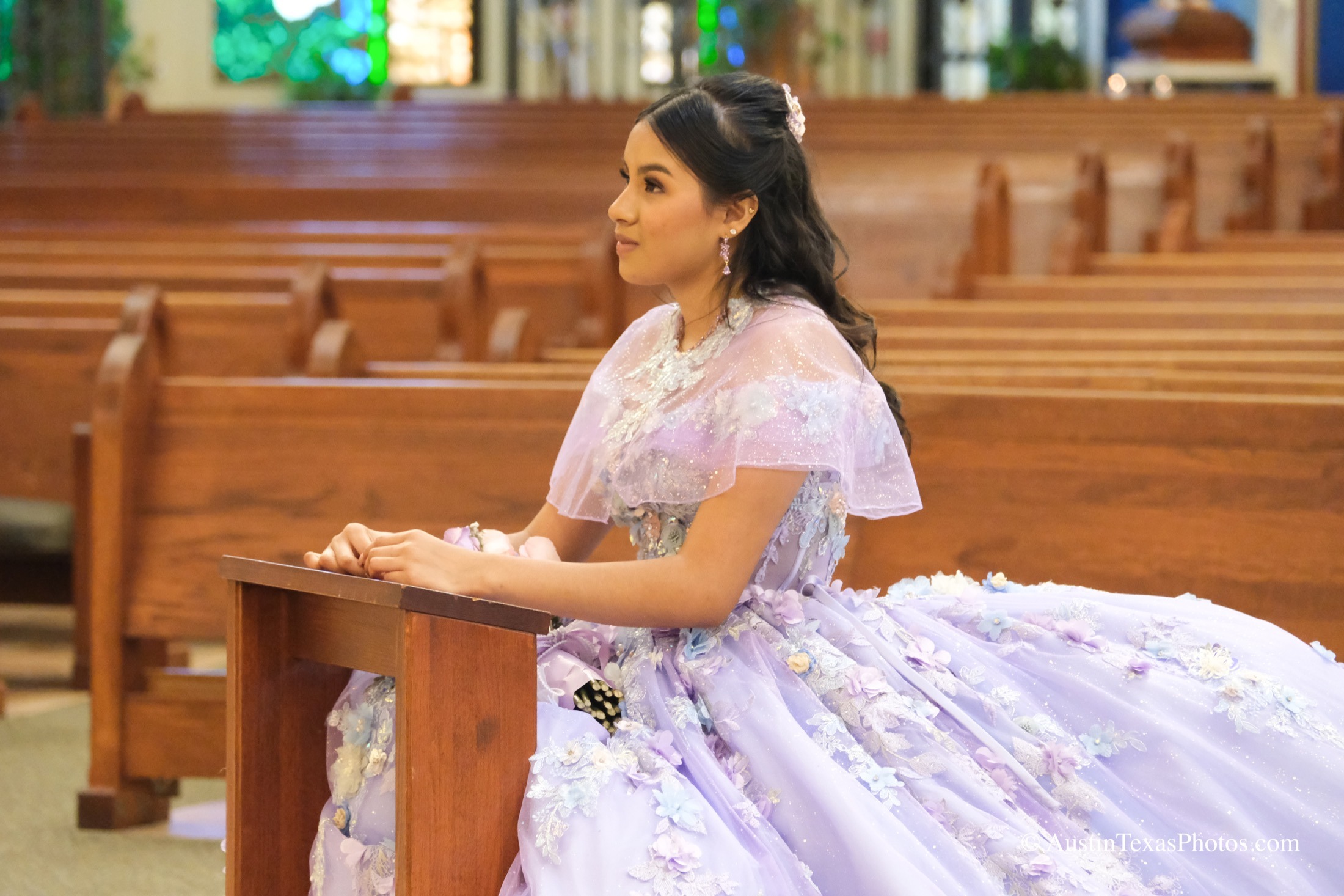 Quinceañera at church ceremony with altar and candles