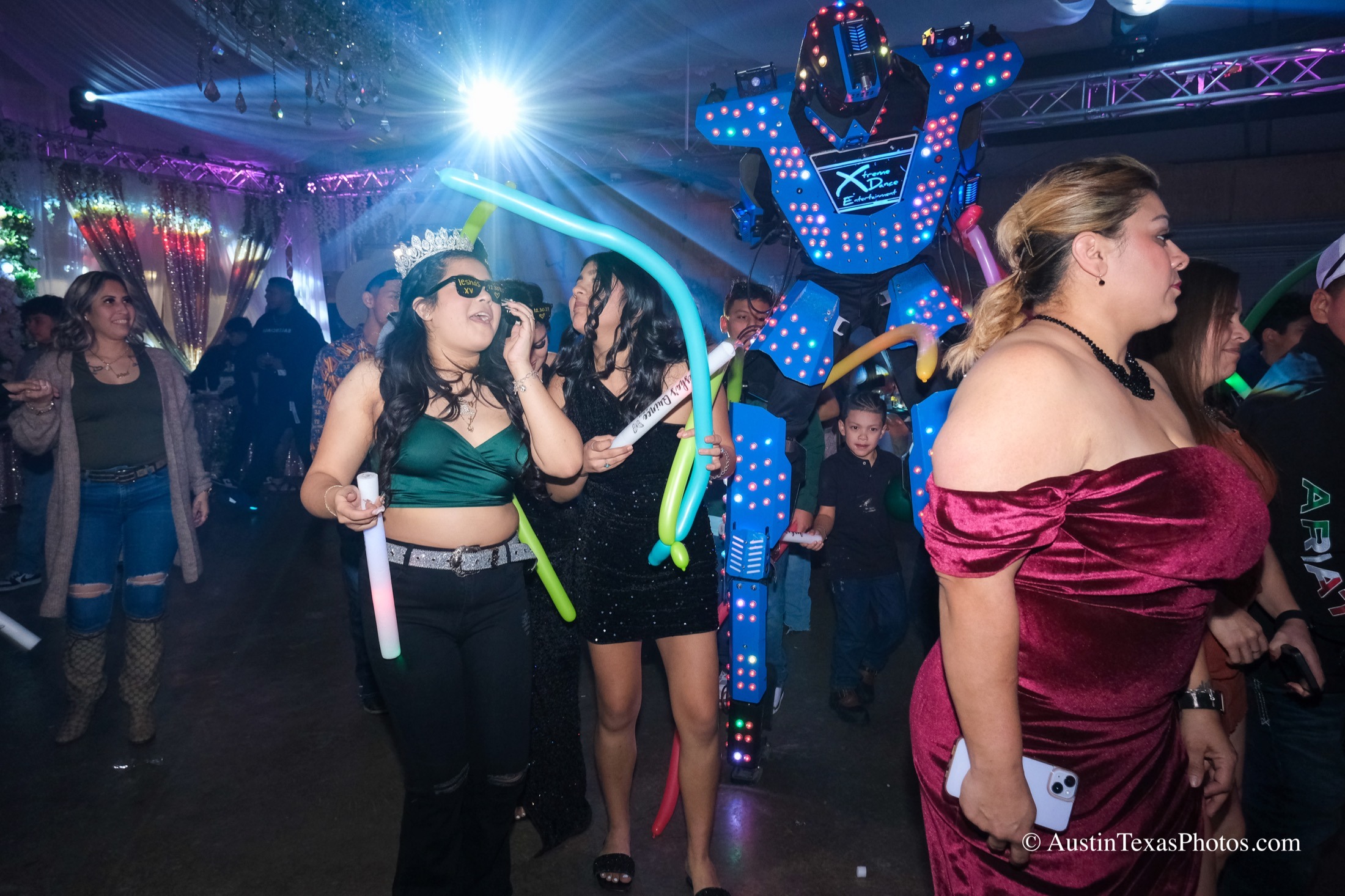 Quinceañera dancing at reception with party lights