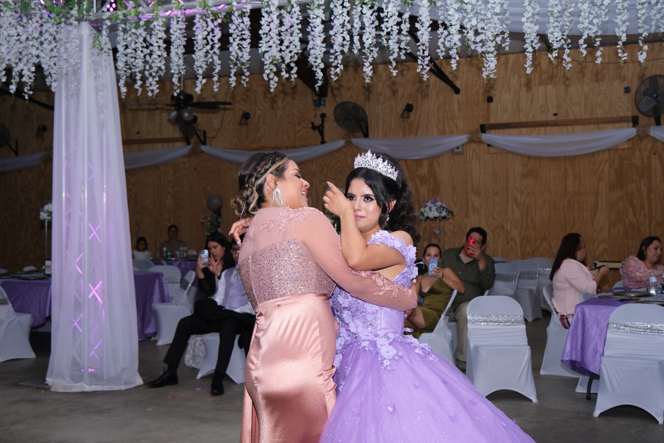 Father and daughter sharing an emotional moment at quinceañera reception