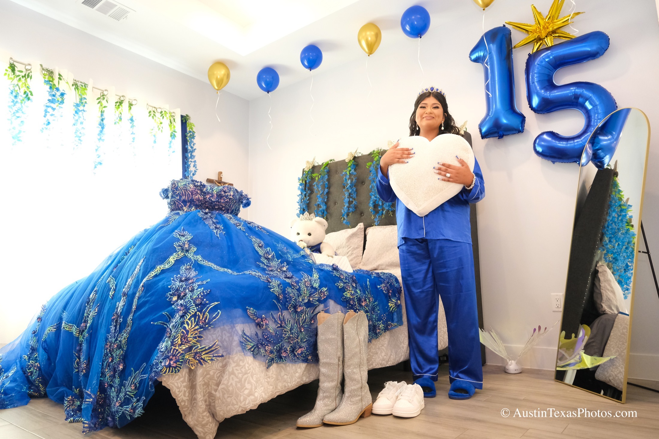 Quinceañera getting ready at home with dress on the bed and 15 balloons