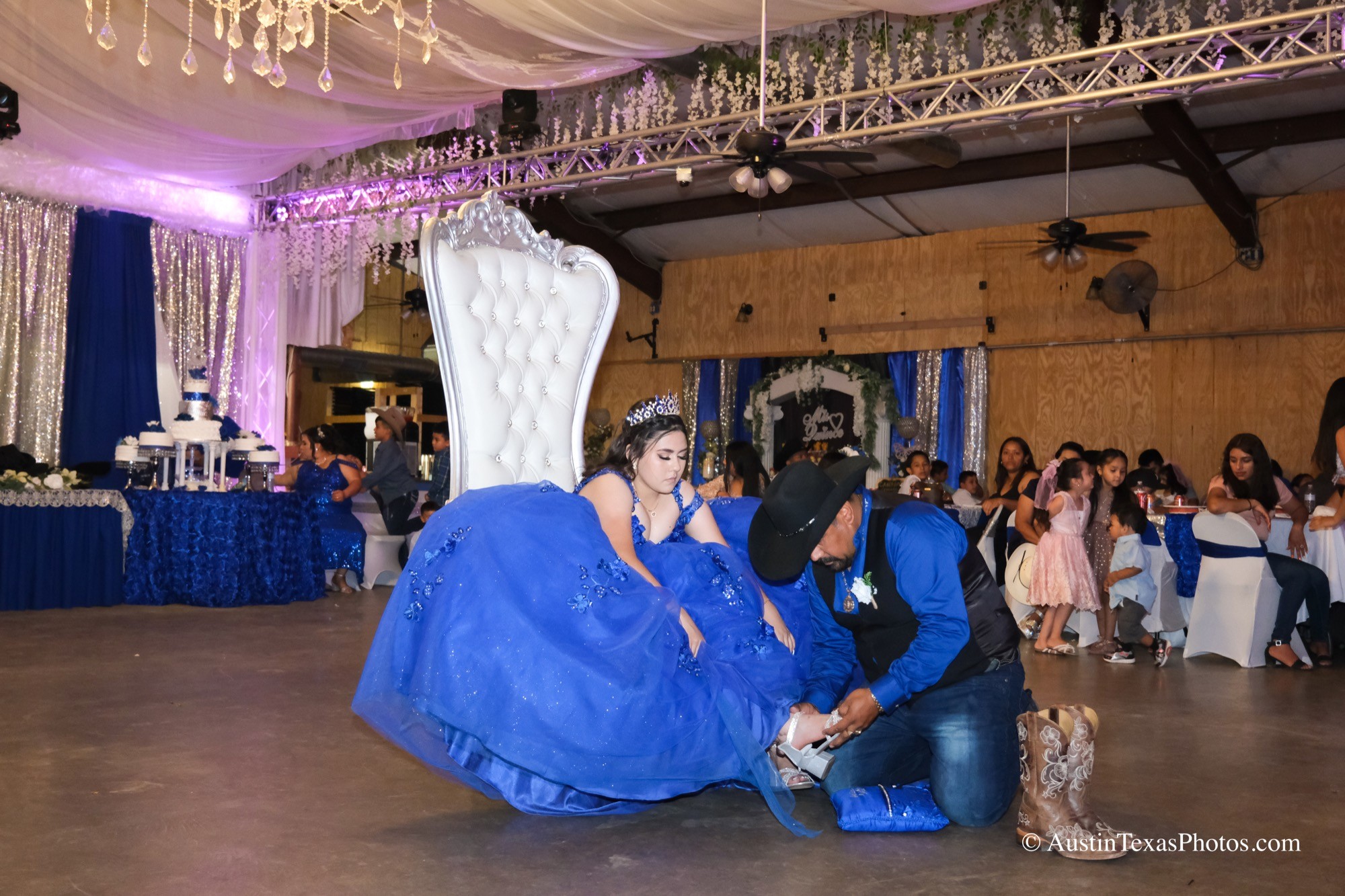 Father changing quinceañera boots to heels at the reception