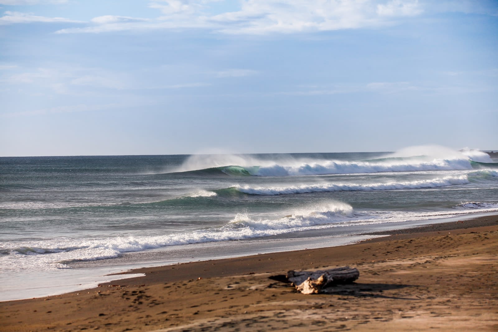 Surfer riding a wave at Playa Guiones, Nosara, Costa Rica